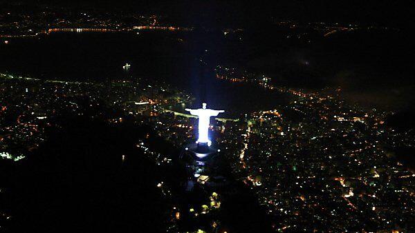 Christus-Statue blickt auf wenig illuminiertes Rio