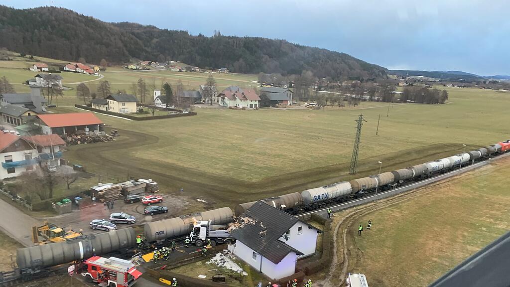 Lkw donnert in Hauswand und Zug