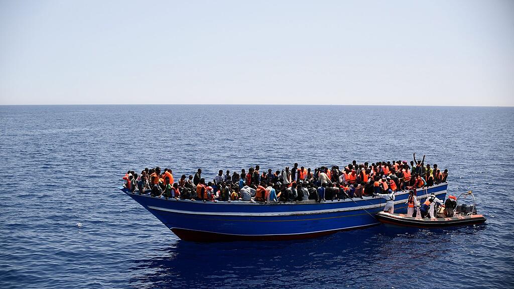 epa04773520 A photo provided by the international aid organization Medecins Sans Frontieres (MSF) shows migrants being transferred from a wooden boat to their rescue ship MY Phoenix in the Mediterranean Sea, 14 May 2015. As first measure, MSF teams provide life jackets to prevent drowning during the rescue operation. MSF reported 561 people rescued from the 18 meters boat. On 28 May, Italian and foreign rescue teams reported another 741 migrants picked up from five different rubber boats.  EPA/I