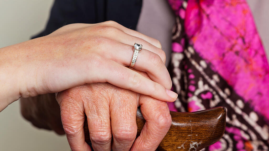 140777_Alte_und_junge_Hand_mit_Gehstock.jpg